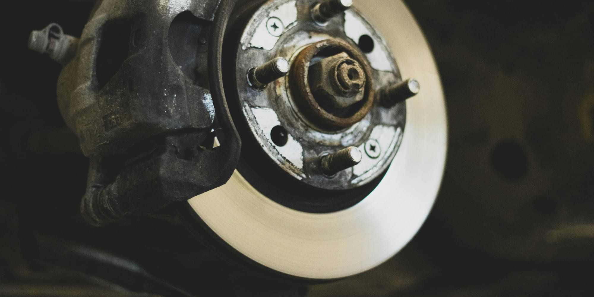 Front disc brake, caliper, and hub with the wheel off during a brake inspection at Master Team Automotive
