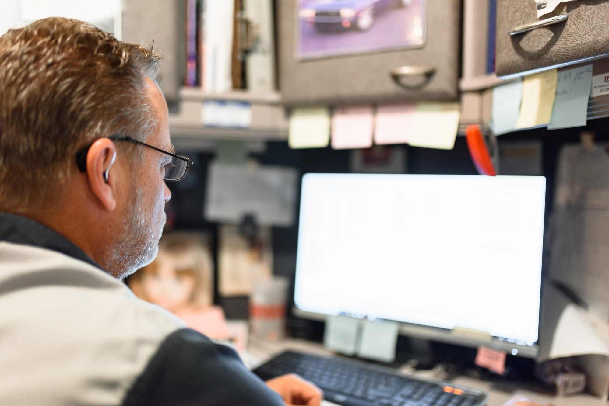 A service writer at the front desk at Master Team Automotive in West Melbourne, Florida